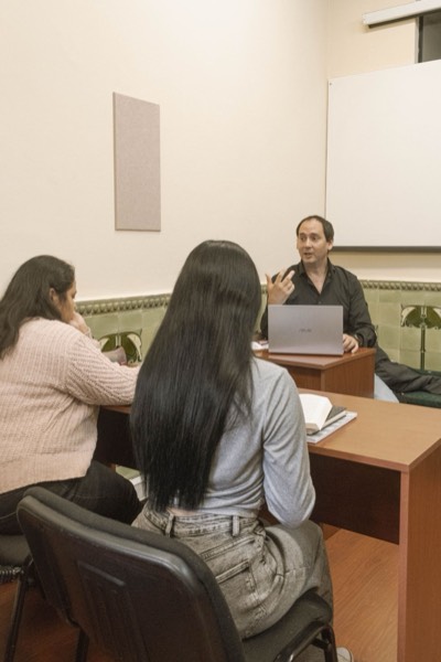 A tutor teaching two students